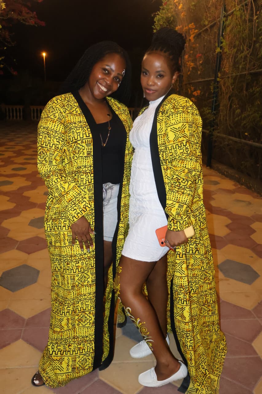 Audience with hands in air in front of stage lights